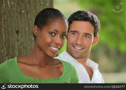 Couple posing by a tree