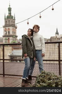 couple posing together roof