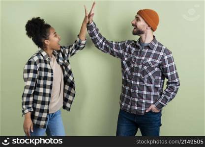 couple posing while high fiving