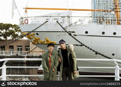 couple posing with boat