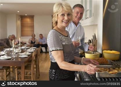 Couple Preparing Food For A Dinner Party