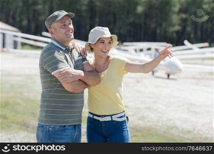 couple preparing for start in private airplane