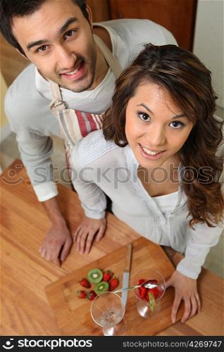 Couple preparing fruit salad