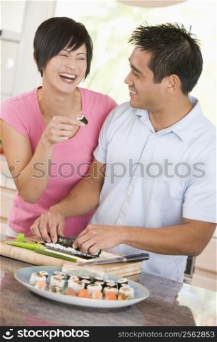 Couple Preparing Sushi Together