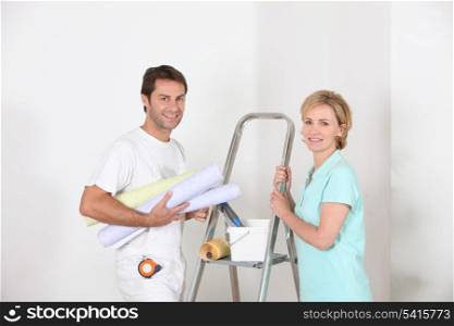 Couple preparing to wallpaper