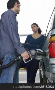 Couple pumping gas