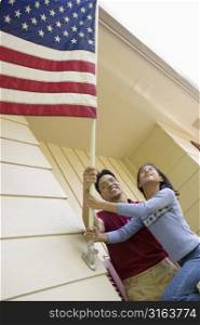 Couple putting up the American flag