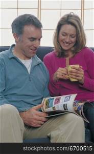 couple reading a magazine together