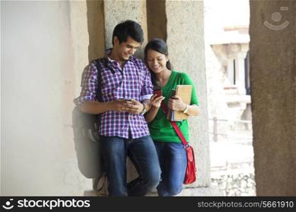 Couple reading an sms on a mobile phone