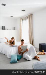Couple reading in bedroom
