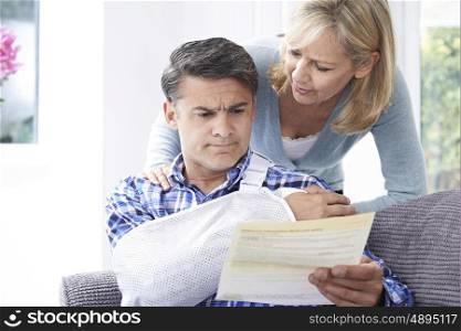 Couple Reading Letter About Husband's Injury