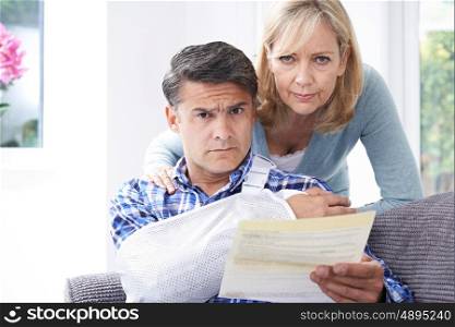 Couple Reading Letter About Man's Injury