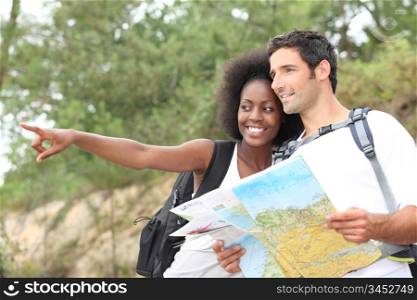 Couple reading map outdoors