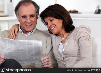 Couple reading newspaper