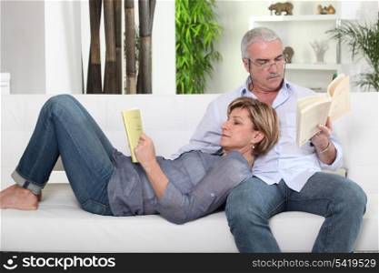 Couple reading on white sofa