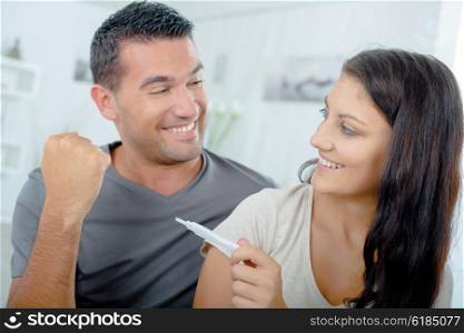 Couple reading pregnancy test result