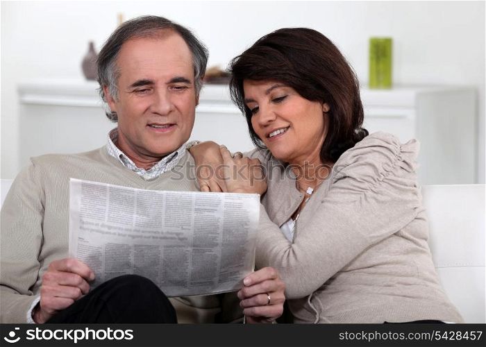 Couple reading the newspaper together