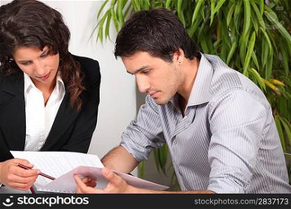 Couple reading through a report