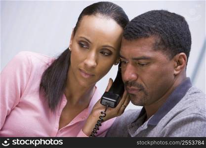 Couple receiving a bad news phone call from clinic