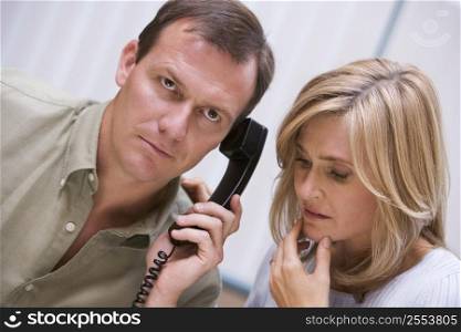 Couple receiving a bad news phone call from clinic