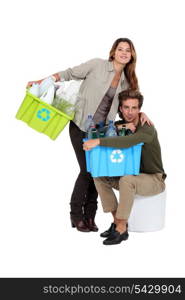 Couple recycling plastic bottles