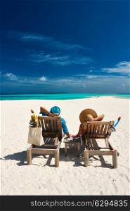 Couple relax on a tropical beach at Maldives