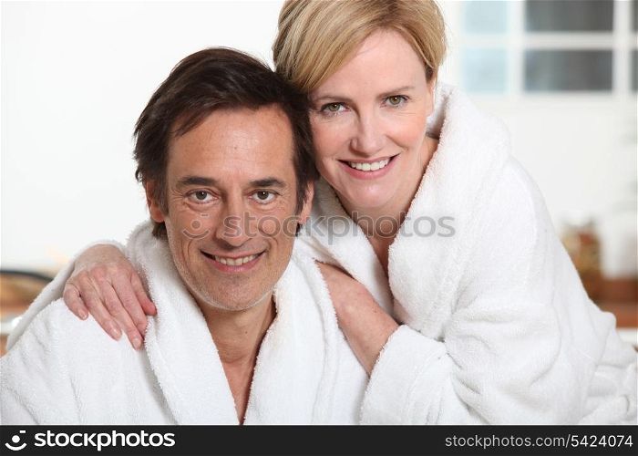 Couple relaxing at home in dressing gowns