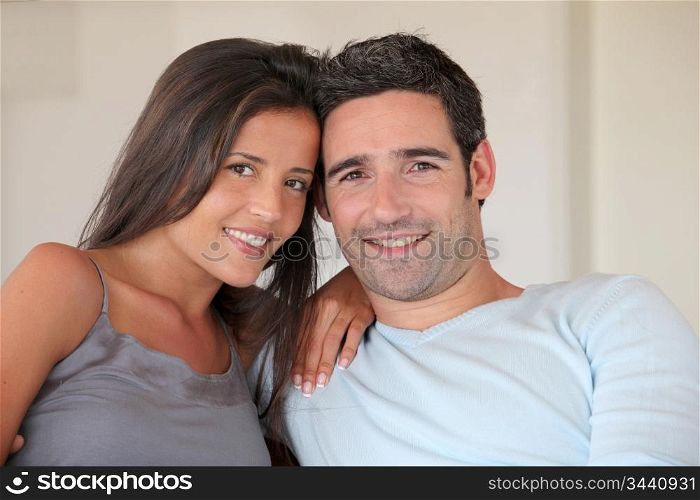 Couple relaxing at home in sofa