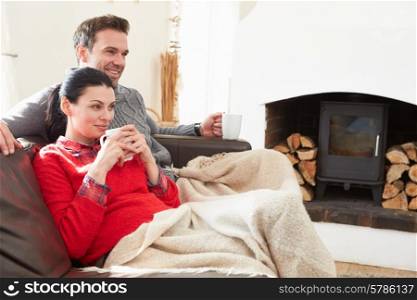 Couple Relaxing At Home Watching Television