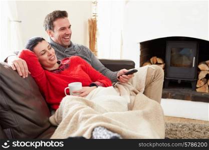 Couple Relaxing At Home Watching Television
