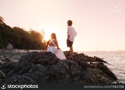 Couple relaxing beautiful sunset on Koh Lipe Beach Thailand ,Summer vacation