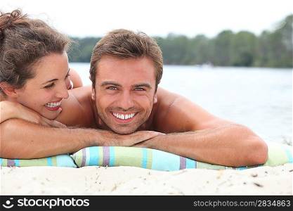 Couple relaxing by the lake