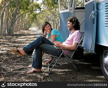 Couple Relaxing by Van