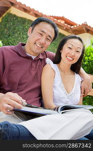 Couple relaxing in back yard, portrait