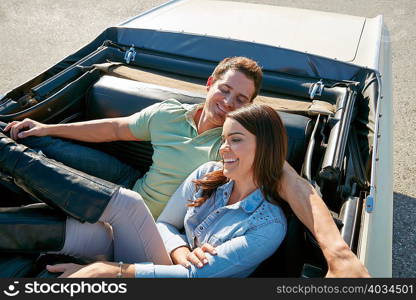 Couple relaxing in convertible car, Los Angeles, California, USA