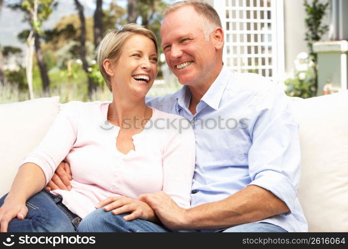 Couple Relaxing In Garden