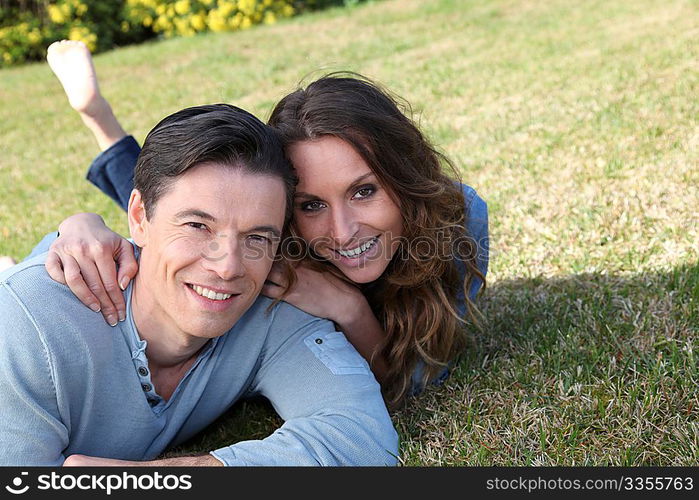 Couple relaxing in home garden