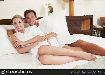 Couple Relaxing In Hotel Room Wearing Robes