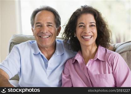 Couple relaxing in living room and laughing