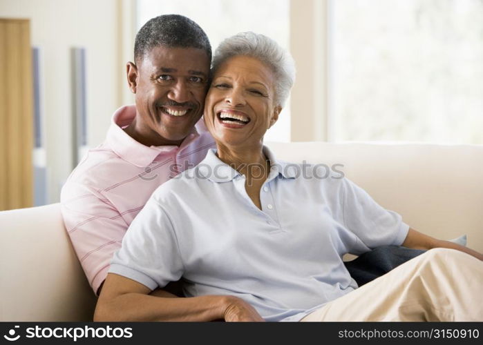 Couple relaxing in living room and smiling