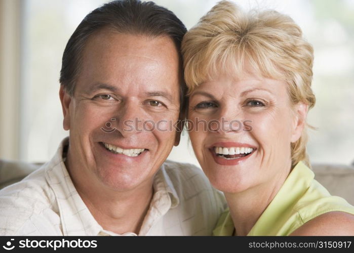 Couple relaxing in living room and smiling