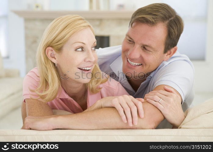 Couple relaxing in living room and smiling