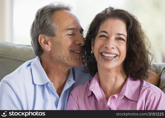 Couple relaxing in living room and smiling