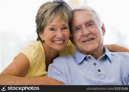 Couple relaxing in living room smiling