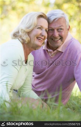 Couple relaxing in park smiling