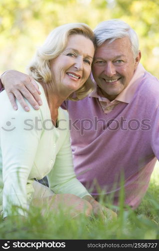 Couple relaxing in park smiling