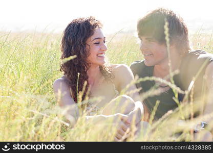Couple relaxing in tall grass
