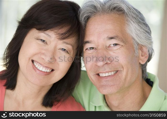 Couple relaxing indoors and smiling