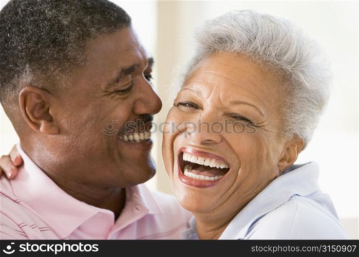 Couple relaxing indoors laughing