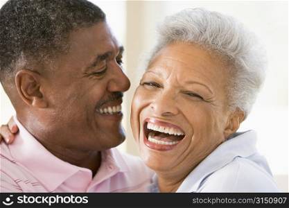 Couple relaxing indoors laughing